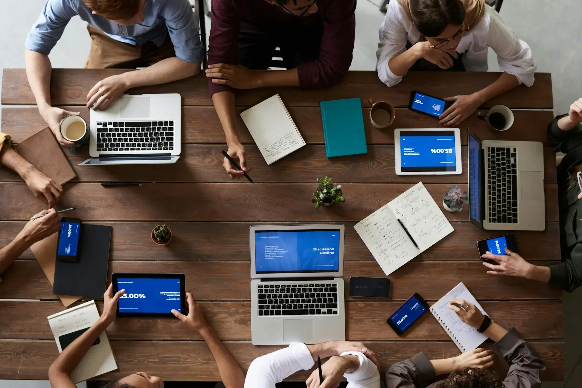 employess-seating-in-office-for-metting-with-laptop-tab-mobile